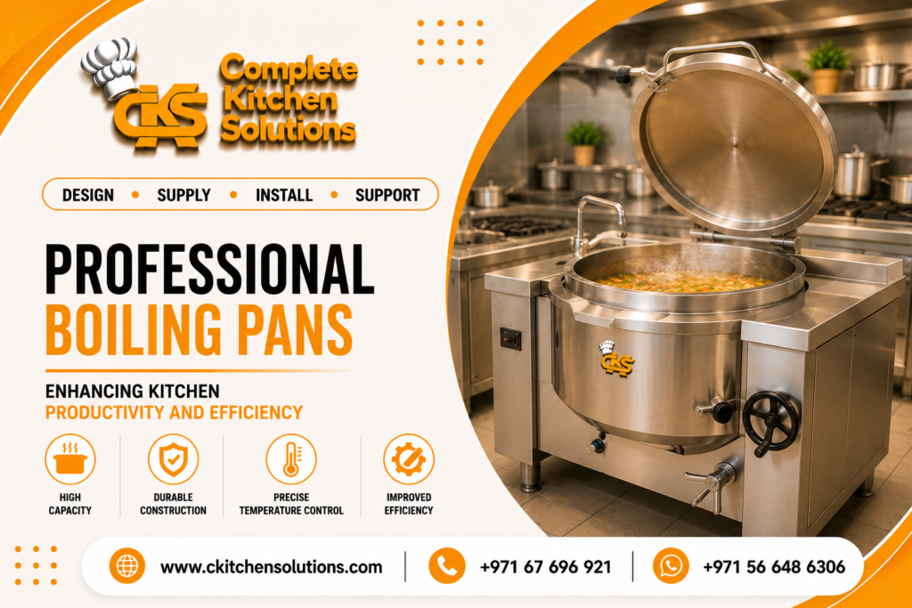 A promotional banner for "Complete Kitchen Solutions" titled "Professional Boiling Pans," featuring a large stainless steel commercial boiling pan with its lid propped open, steaming with vegetable soup inside a professional industrial kitchen.