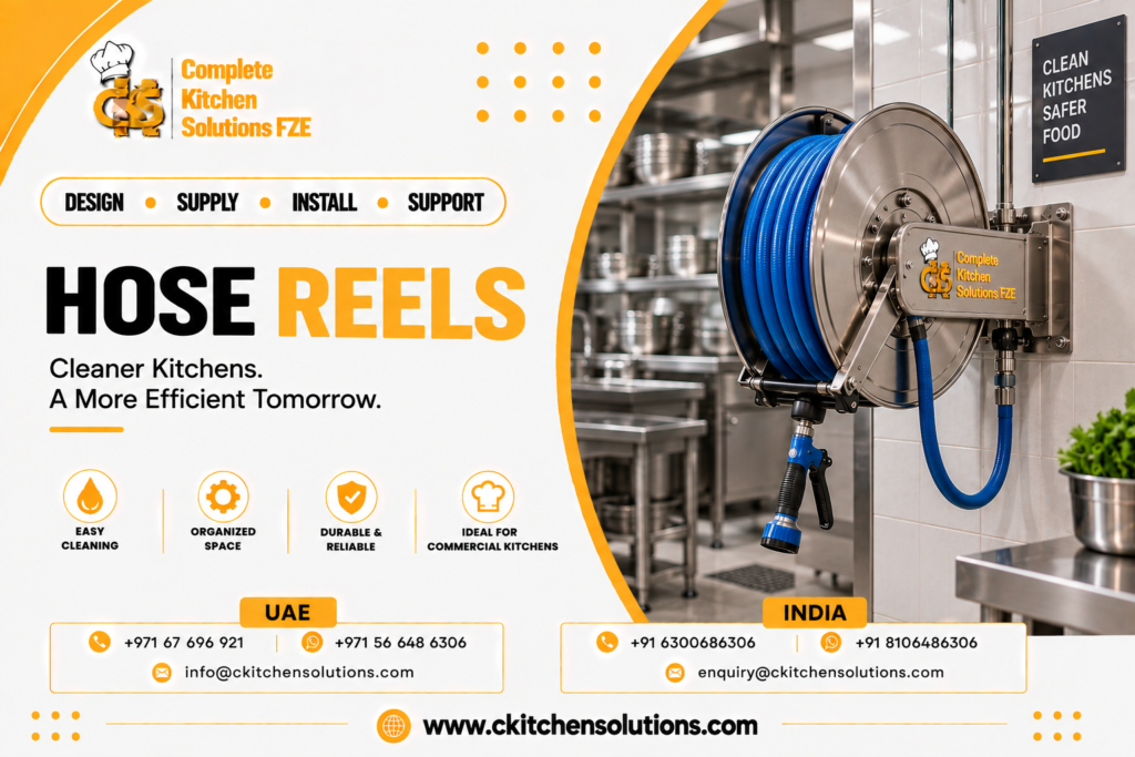 A promotional banner for "Complete Kitchen Solutions FZE" titled "Hose Reels: Cleaner Kitchens. A More Efficient Tomorrow," showcasing a wall-mounted stainless steel retractable commercial hose reel with blue washdown hose, high-pressure spray gun nozzle, branded mounting bracket, and stainless steel kitchen shelving in the background.