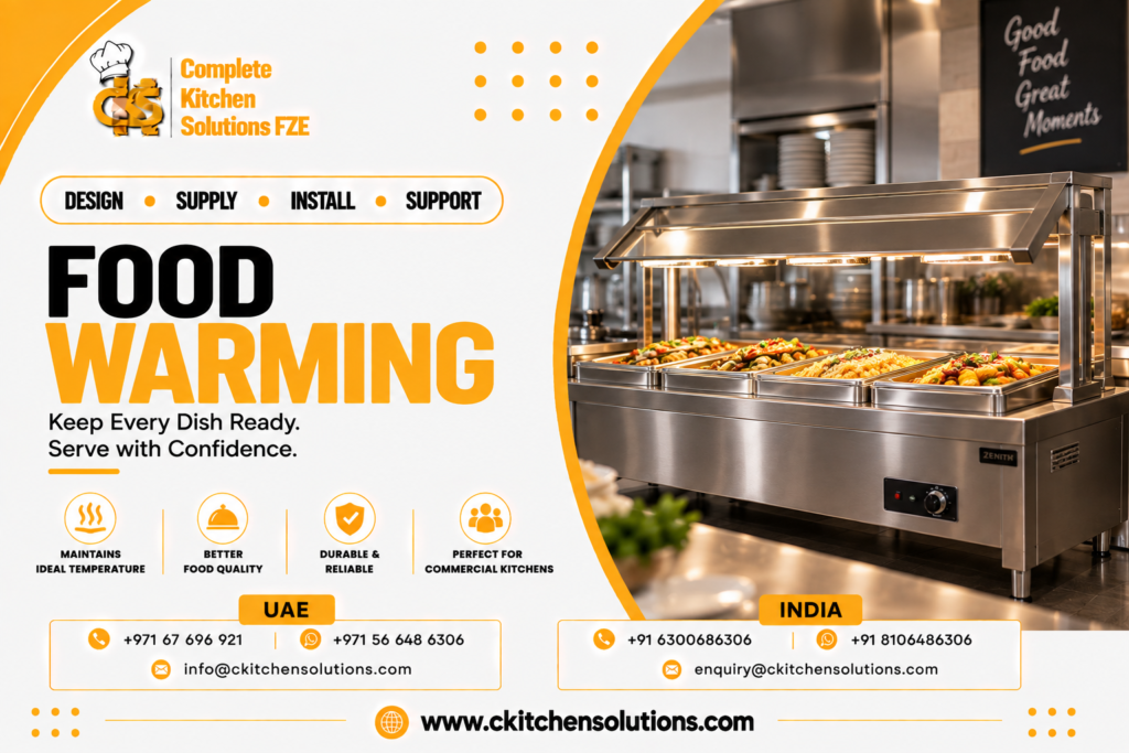 A promotional banner for "Complete Kitchen Solutions FZE" titled "Food Warming: Keep Every Dish Ready. Serve with Confidence," featuring a commercial stainless steel Zenith electric bain-marie food warmer with an integrated glass sneeze guard, overhead heating lamps, and drop-in gastronorm pans holding warm buffet dishes in a restaurant kitchen.